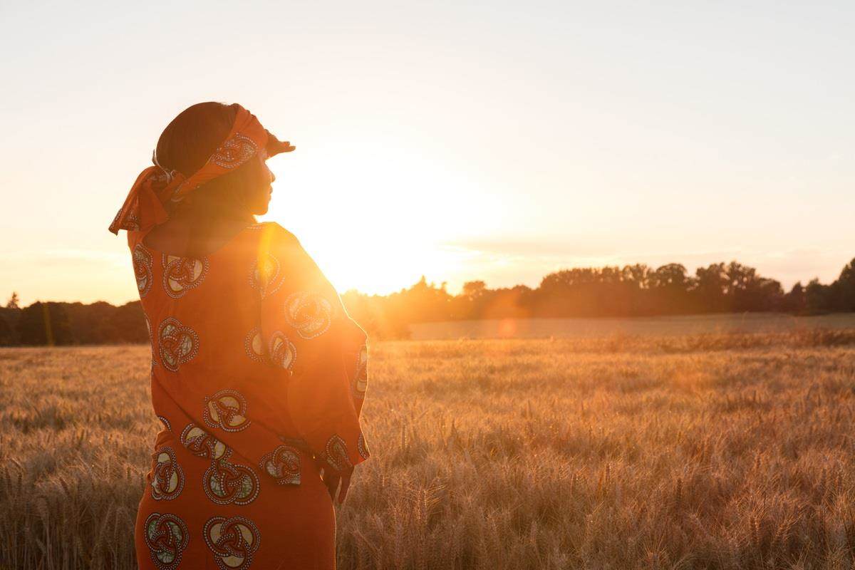 indigenous woman looking over field into distance
