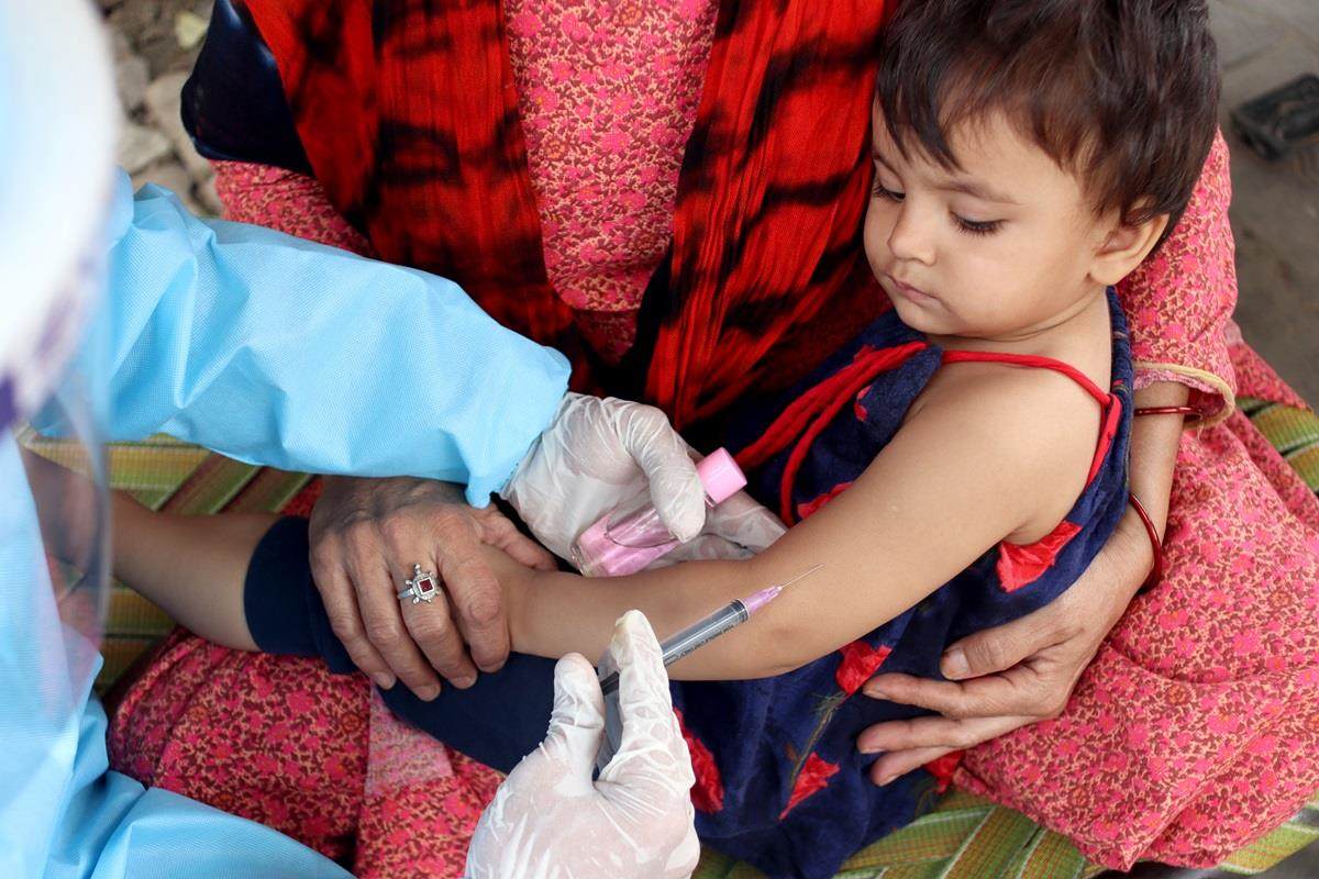 Young boy receiving COVID jab vaccine