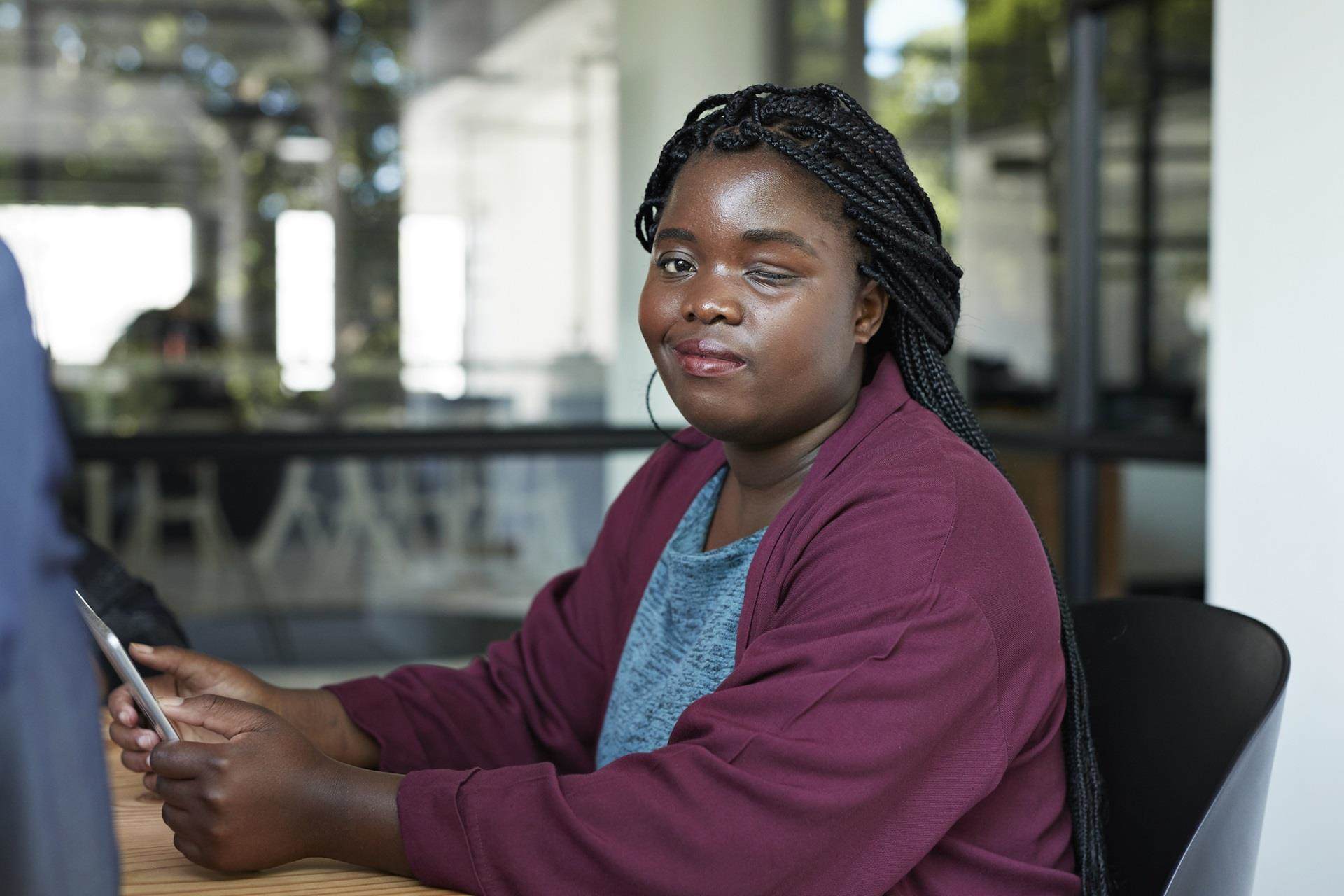 Person living with blindness reading brail