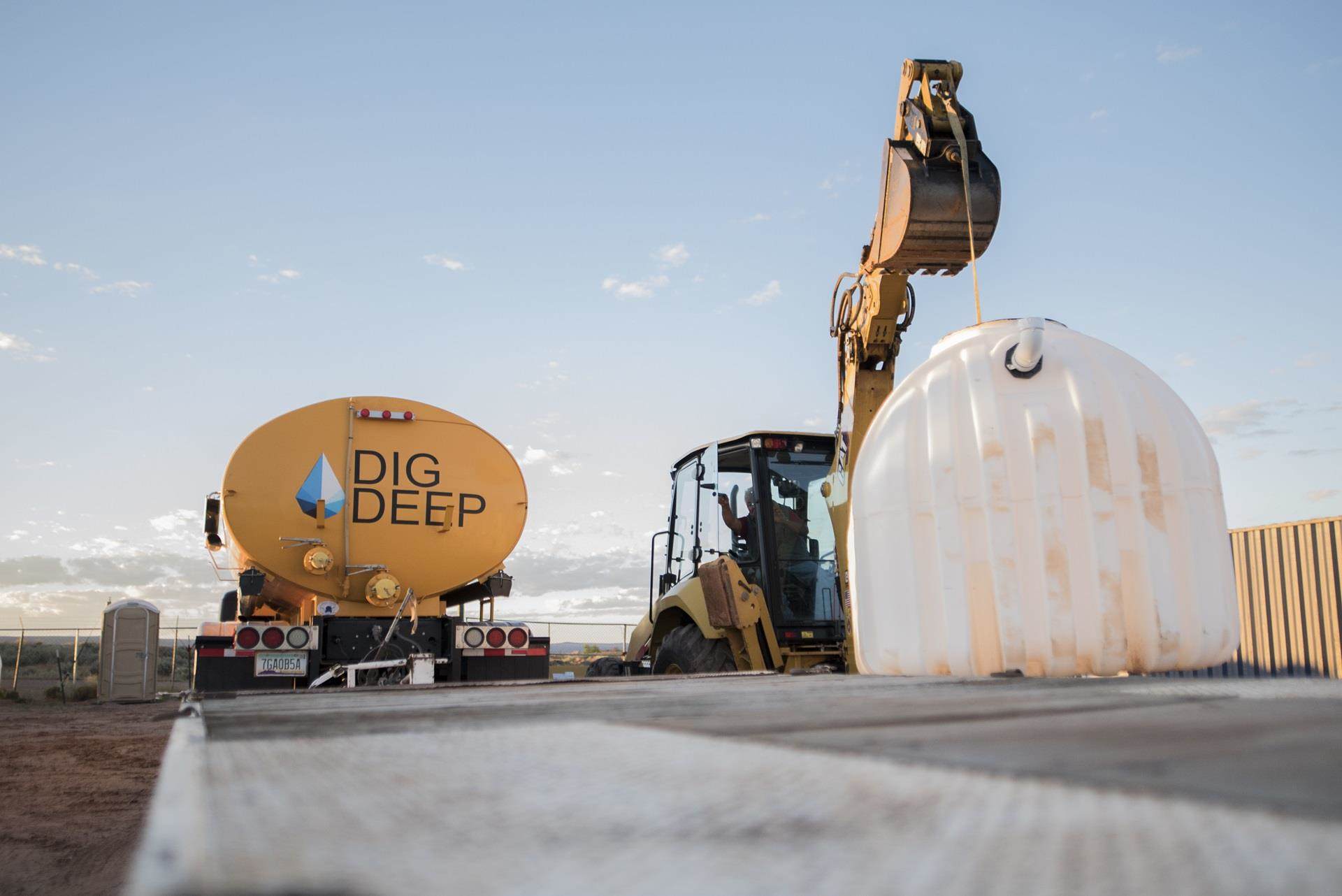 A DigDeep water truck stands by as a water storage system is installed