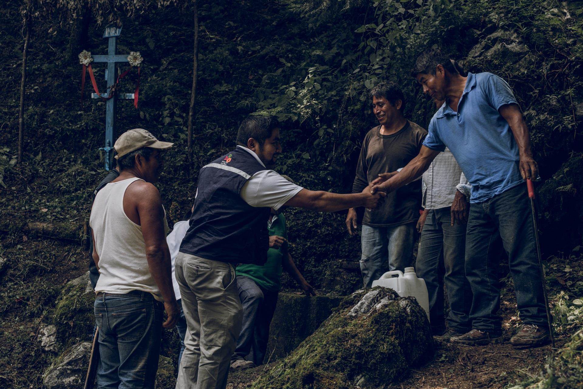 Indigenous men speaking about rainwater collection