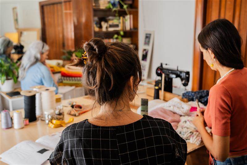 Stock image of women working on sewing projects