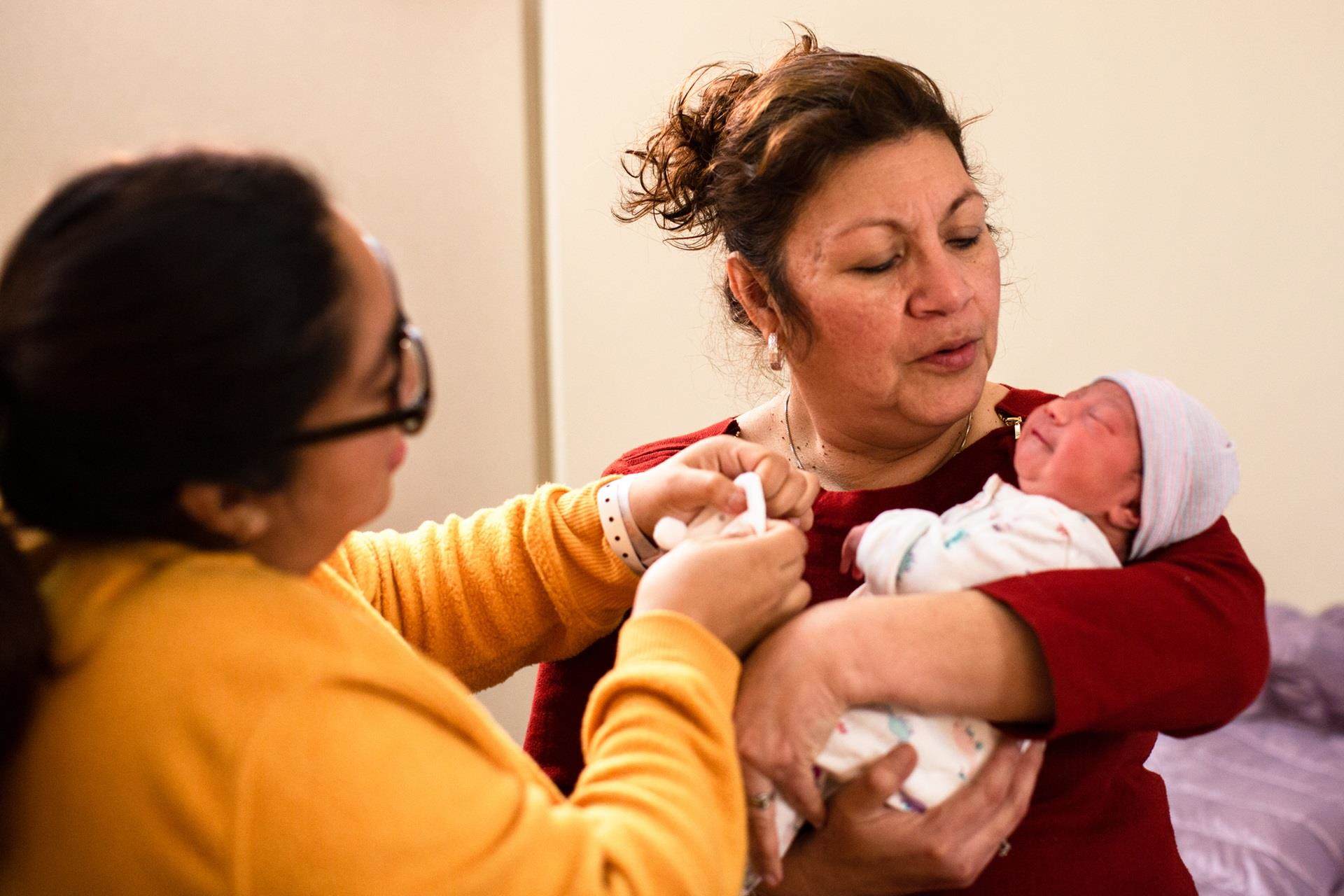 Migrant mother holding child Project HOPE