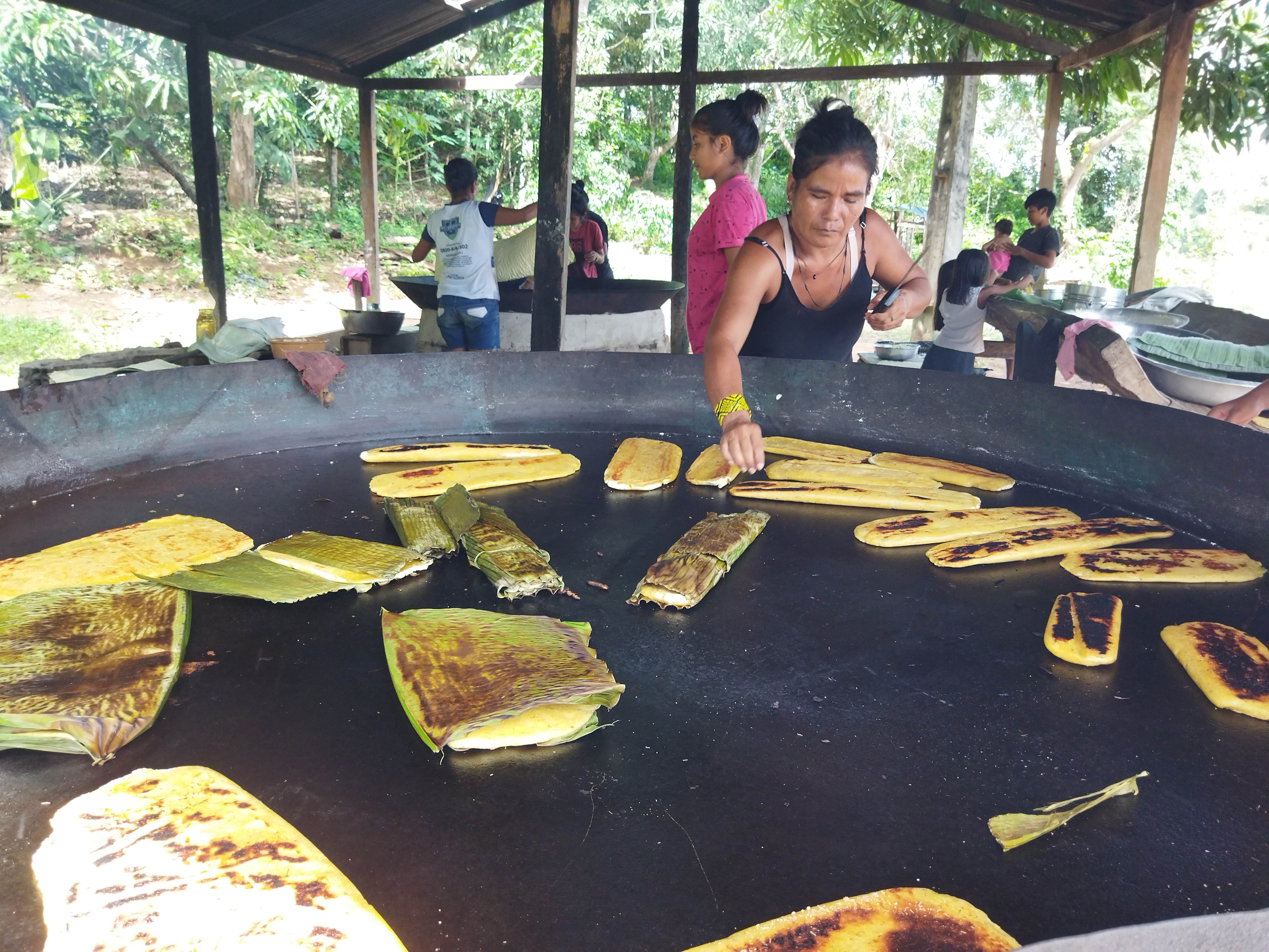 Indigenous woman cooks using skills learned from Instituto Amazonas