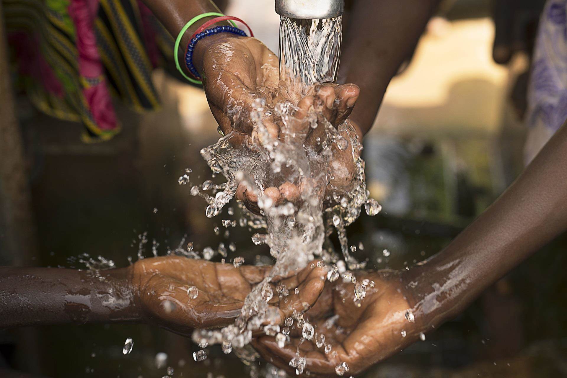 hand reaching for fresh drinking water