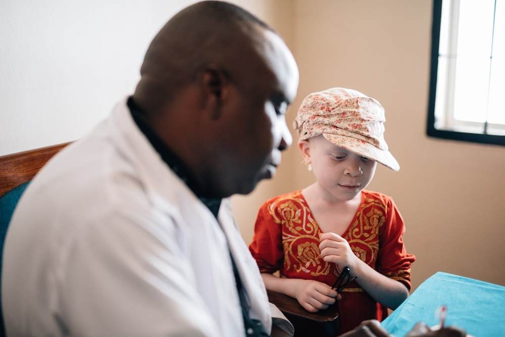 Young girl with albinism speaks with doctor via Standing Voice