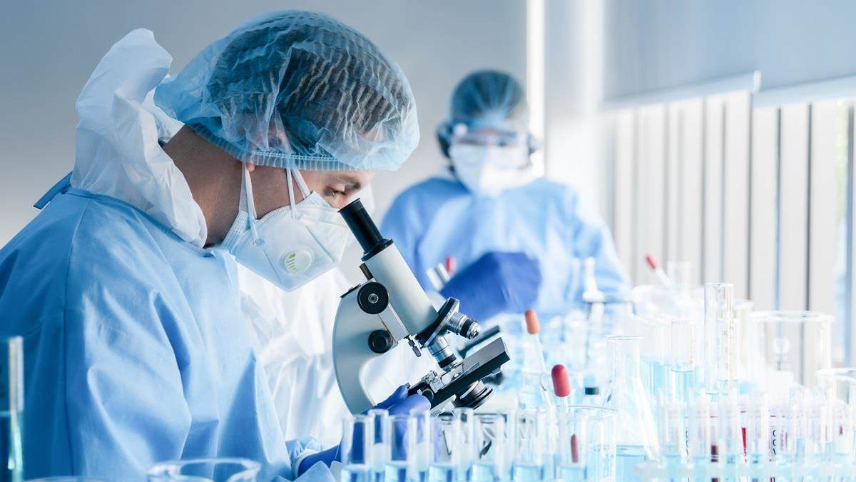 research scientist looking into microscope